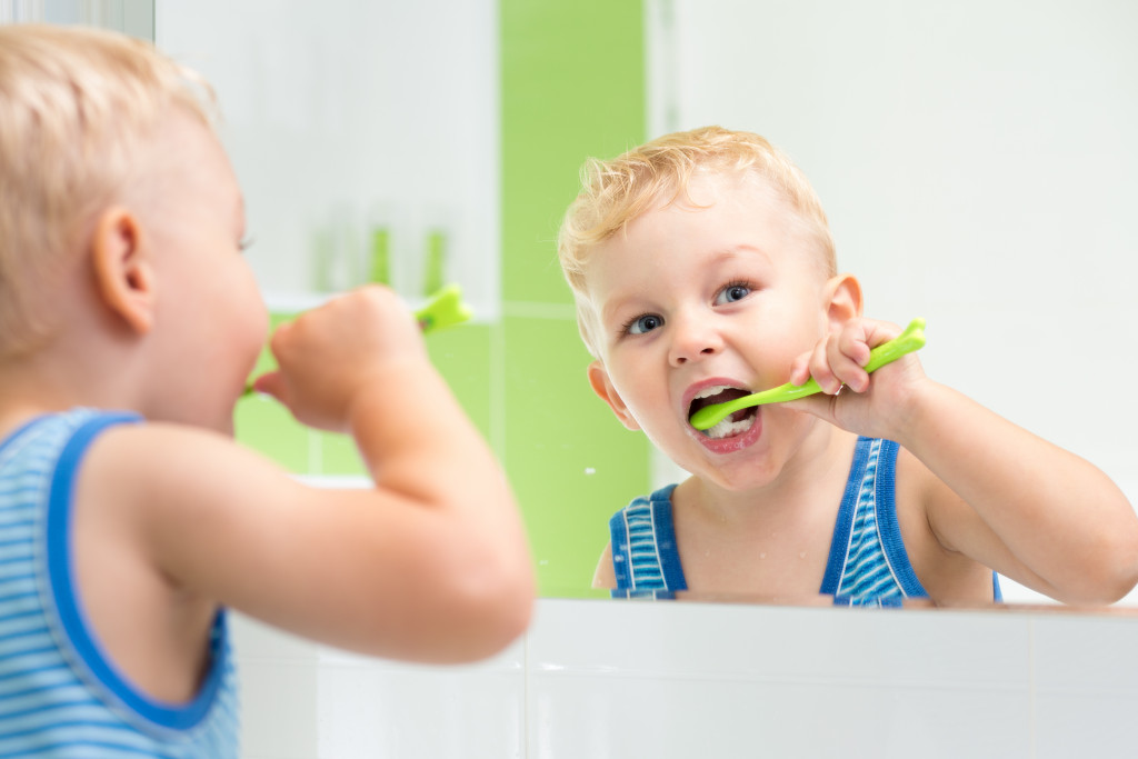child brushing his teeth