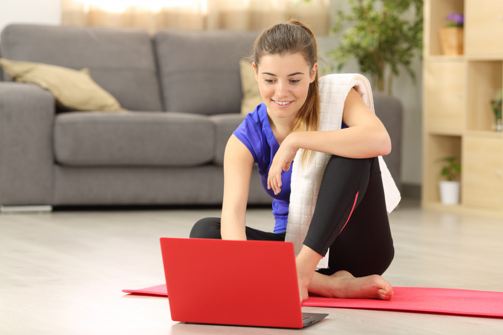 woman checking her red laptop for routines she can do