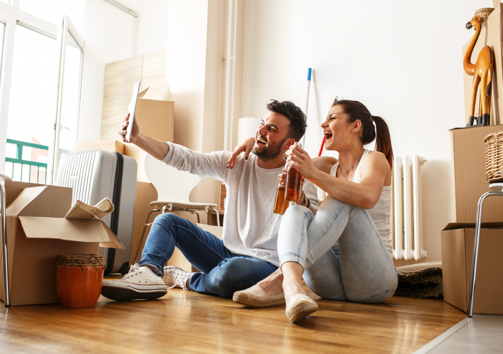 couple taking a picture on their new house