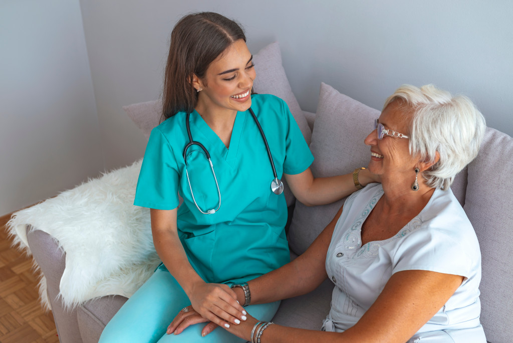 a senior woman holding a healthcare professional 