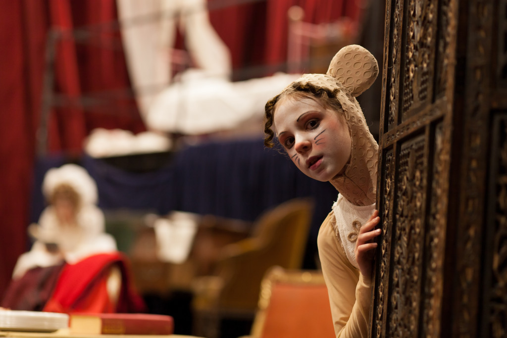 A student wearing a costume for a theater production