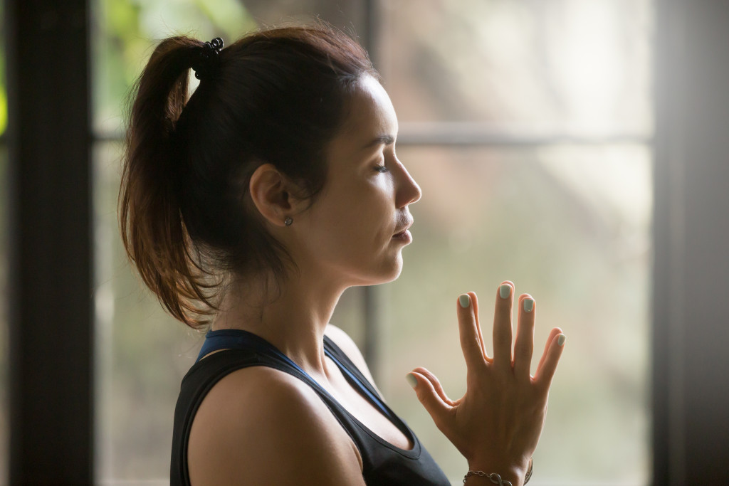 woman hands pressed together during meditation