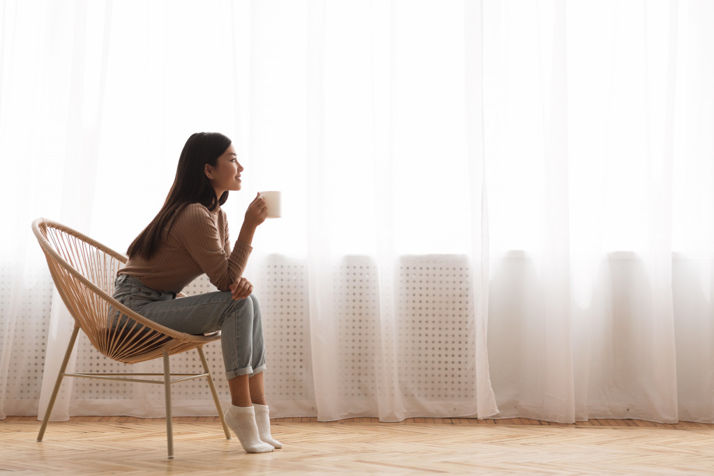 woman relaxed while drinking from her cup