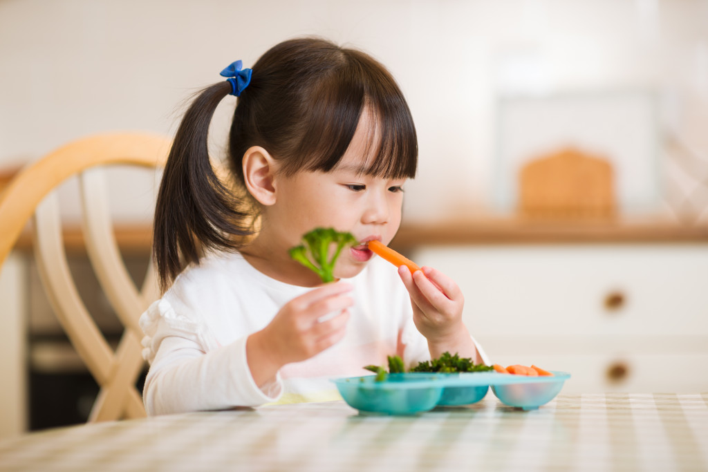 child eating vegetables
