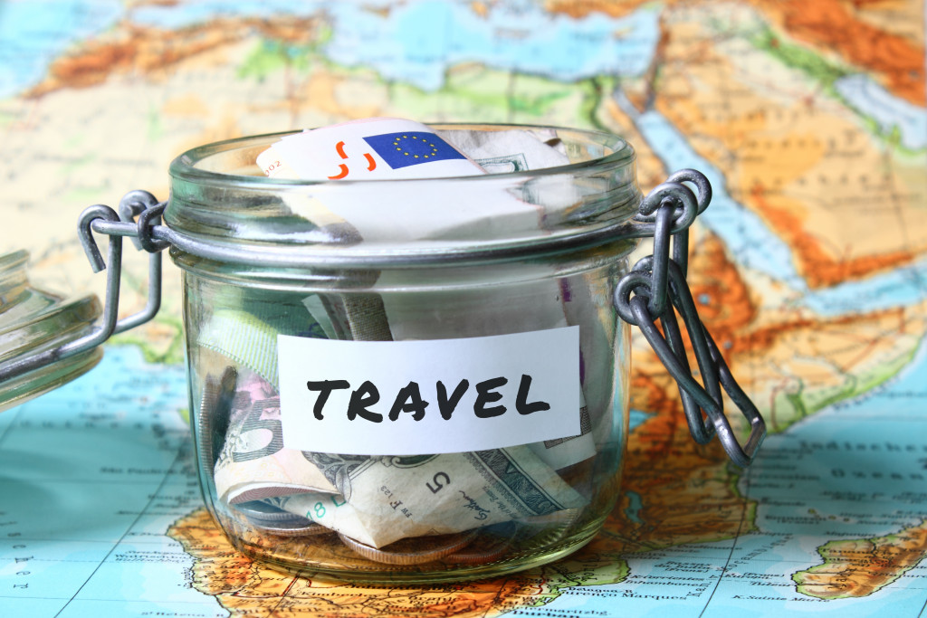 Travel budget - vacation money savings in a glass jar