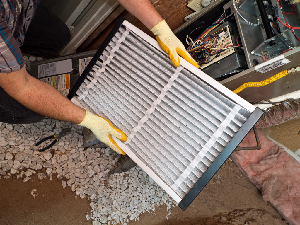 Hispanic airconditioning repair man performing maintenance