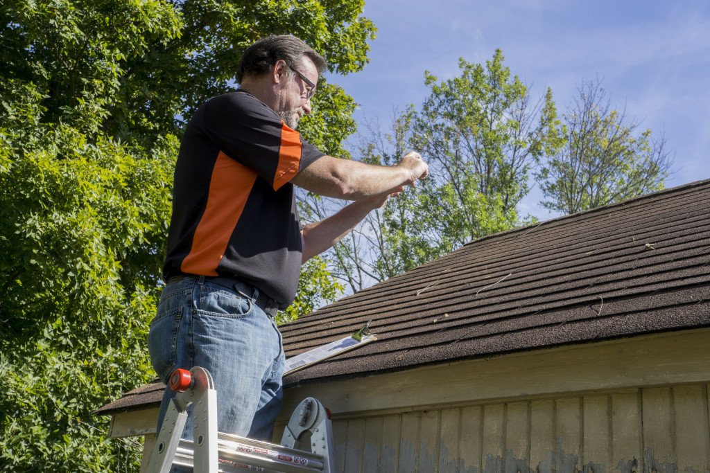 man checking roof condition