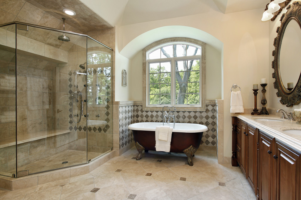 master bathroom with hot tub and glass shower