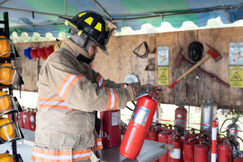 A fireman preparing fire extinguisher