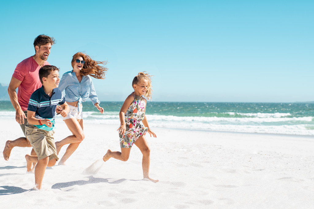 family having fun by the beach