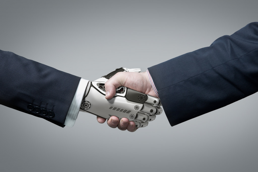 artificial intelligence concept man shaking hands with robot