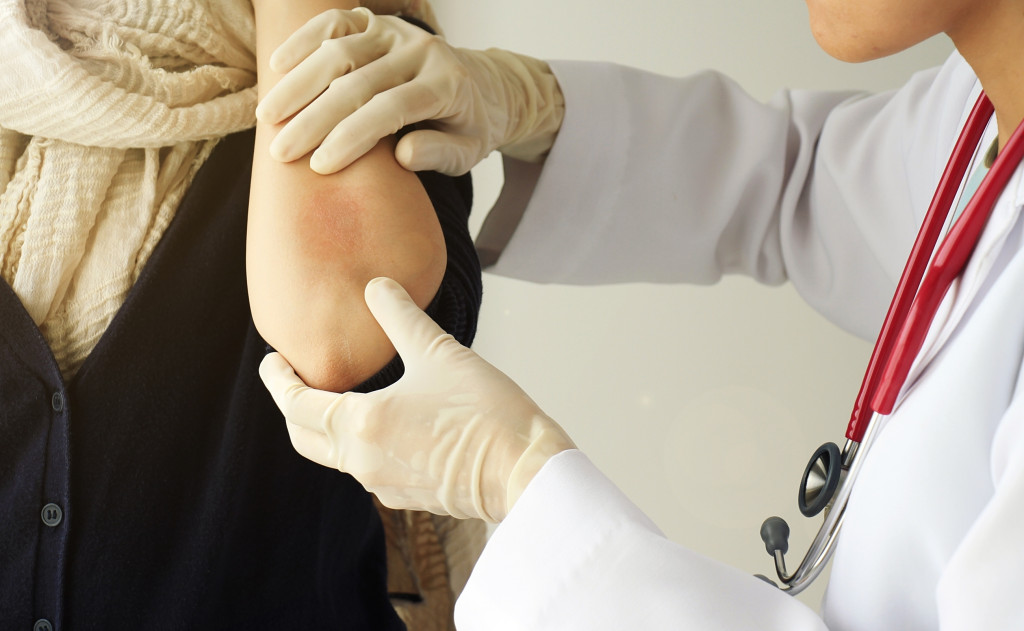 dermatologist doing treatment on female patient with eczema