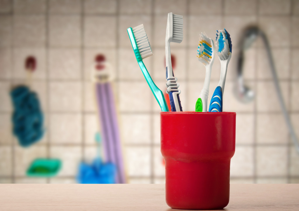 set of toothbrushes at home in red cup