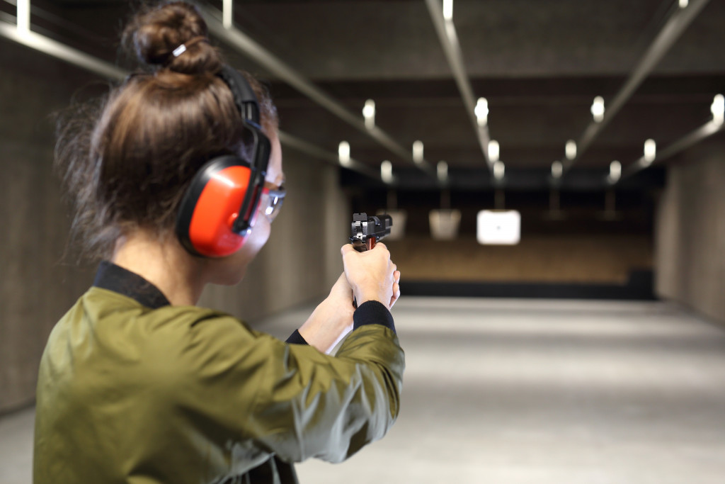 woman shooting target in shooting range