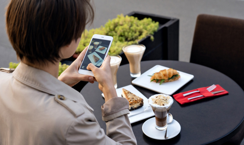 a woman taking a photo of her food