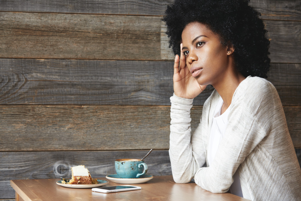 woman eating alone unhappy