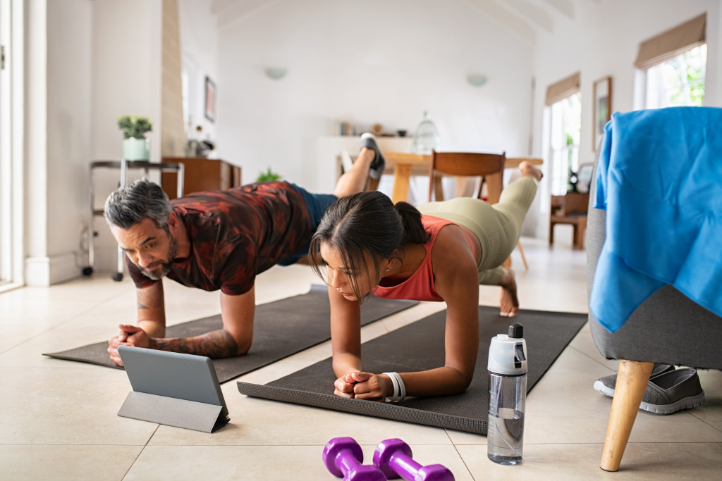 A couple doing home workout via training video online