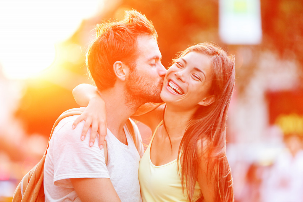 A man kissing a woman on the cheek