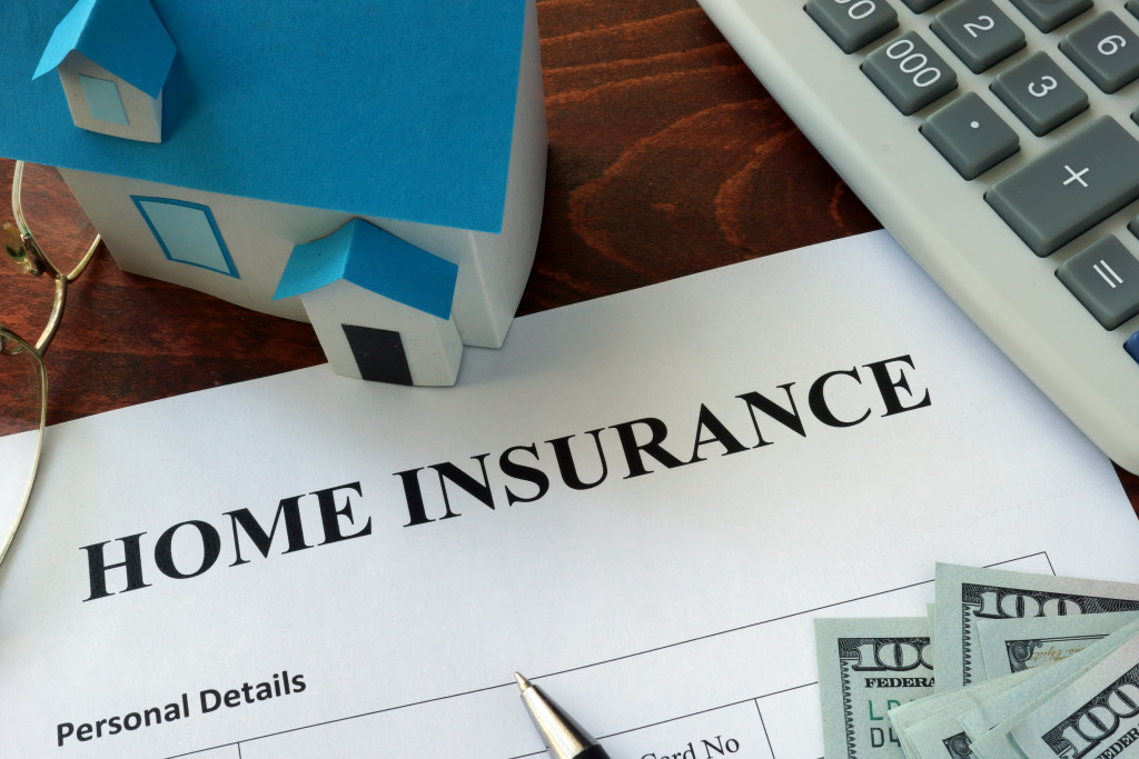 Home insurance form with pen and calculator