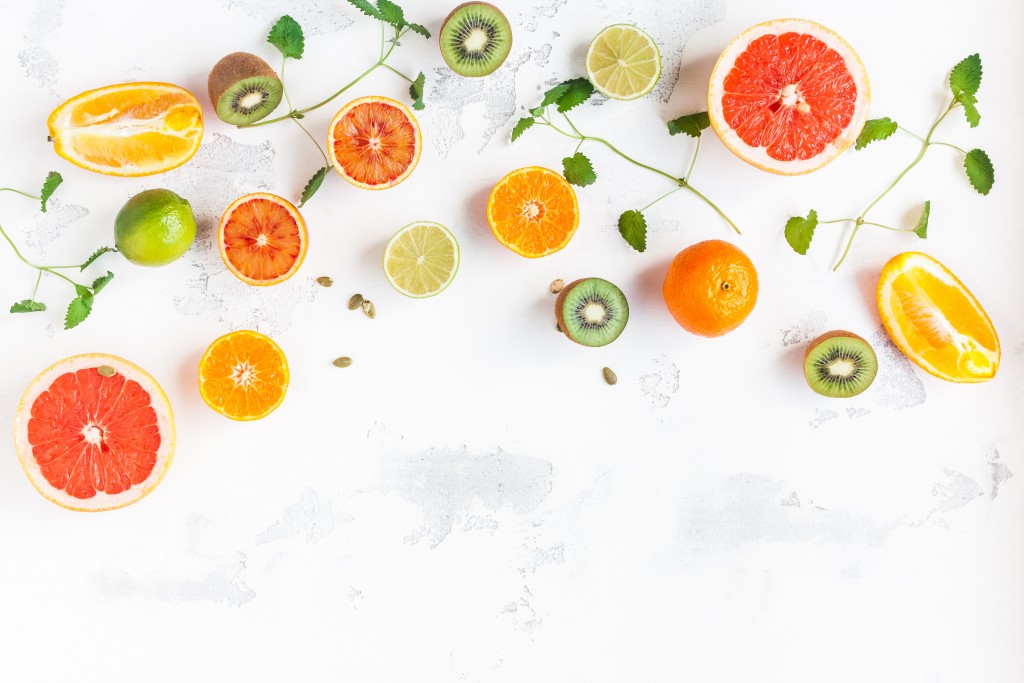 Various slices of citrus fruit on a white background