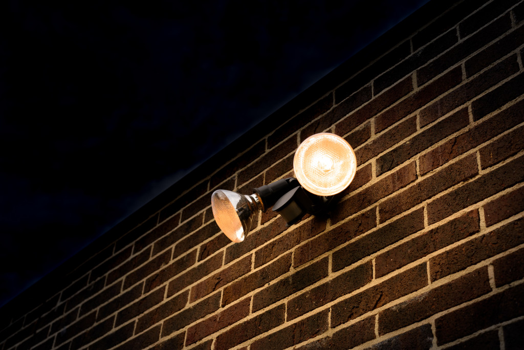 A motion sensor light installed on a brick wall