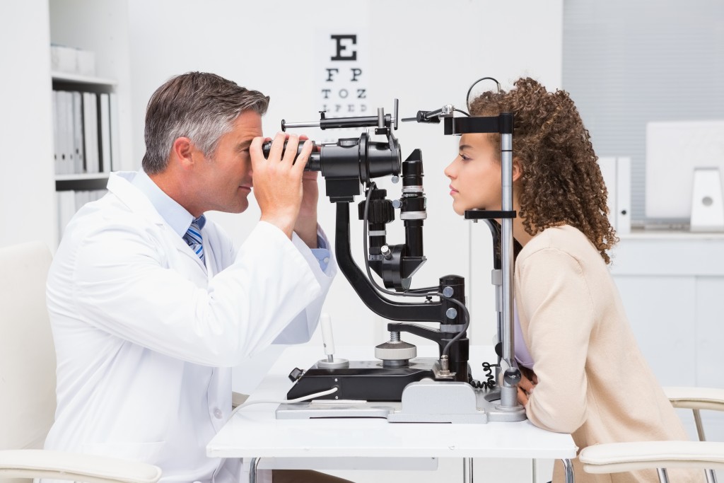 A woman getting her eyes checked by an optometrist