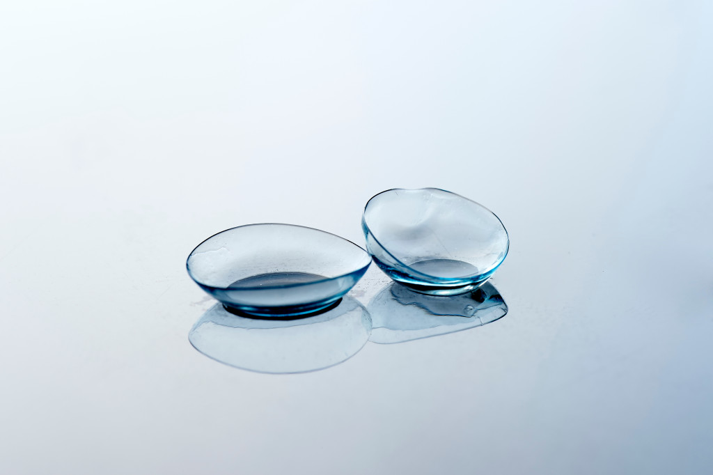 A pair of contact lenses on a glass table