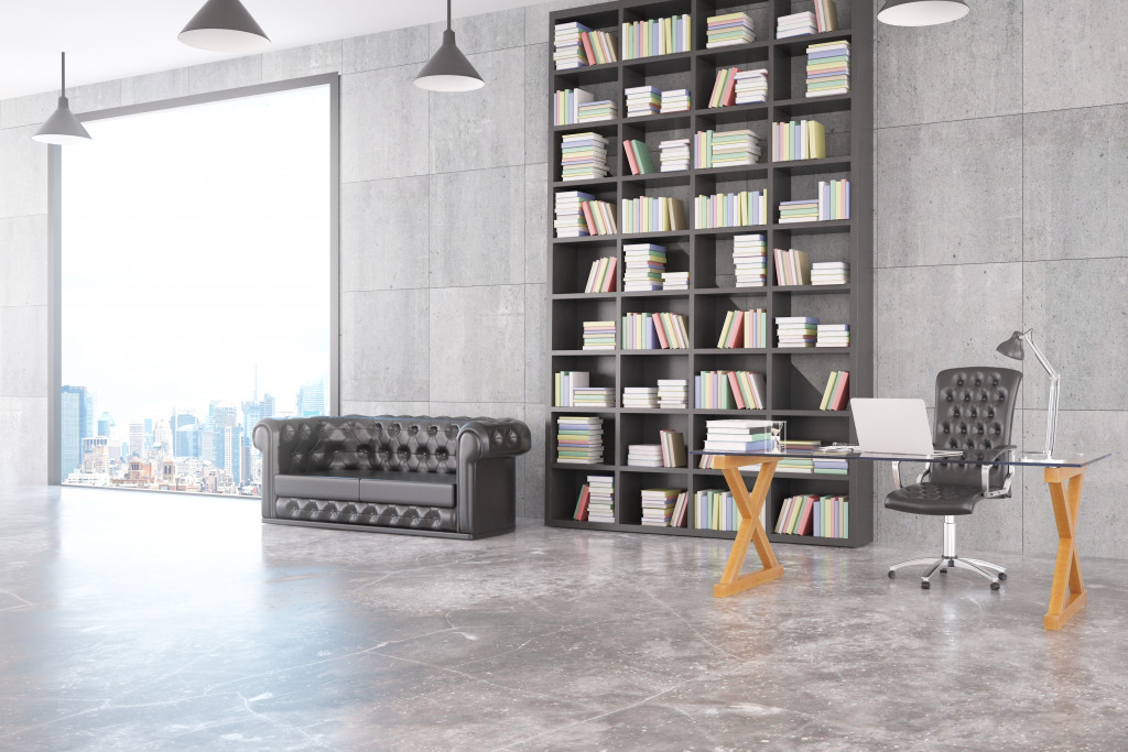 modern loft office with stack of books and beautiful city view