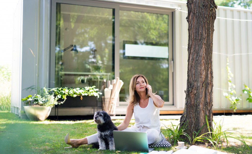 woman under the tree in her backyrad