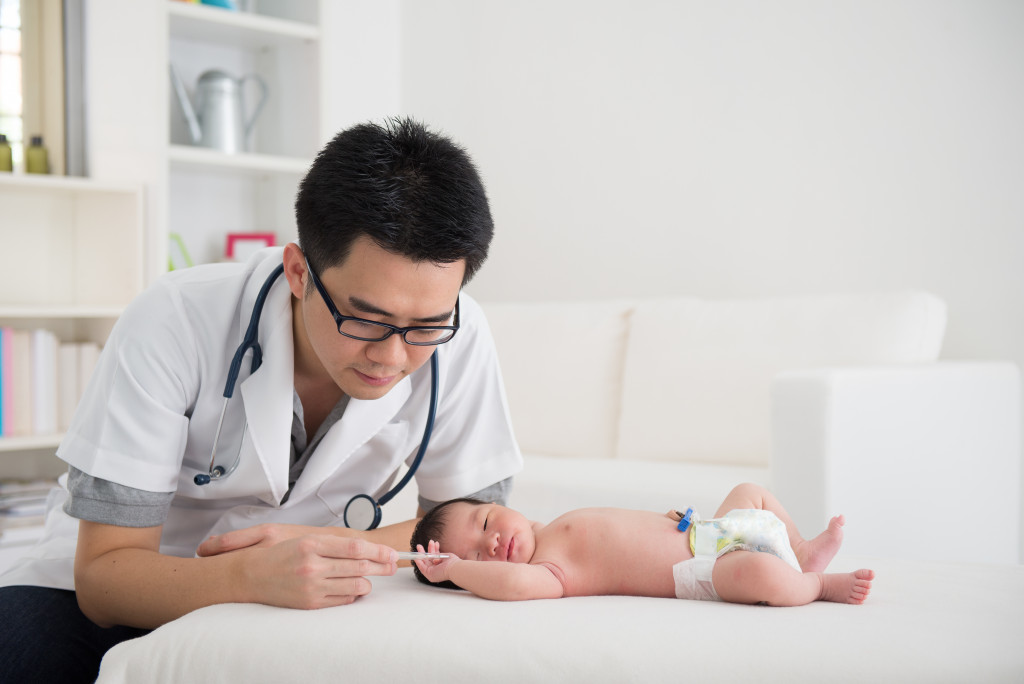 doctor checking baby's health