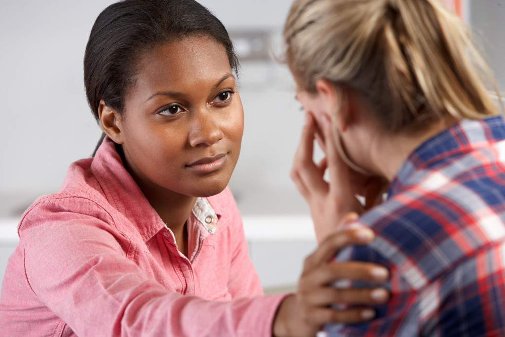 A psychiatrist comforting a woman