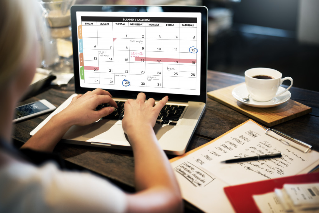 woman checking and editing her schedule in her laptop