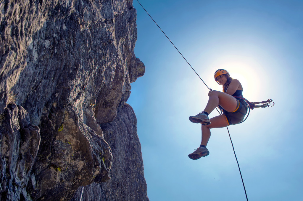 abseiling from a steep rock