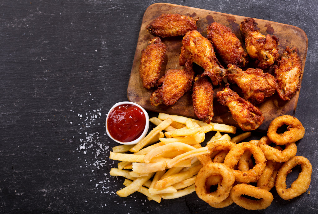 chicken wings with fries and onion rings