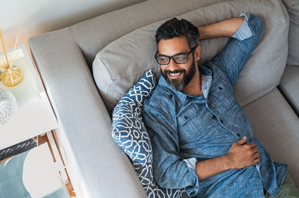 Mature man relaxing on a sofa at home.