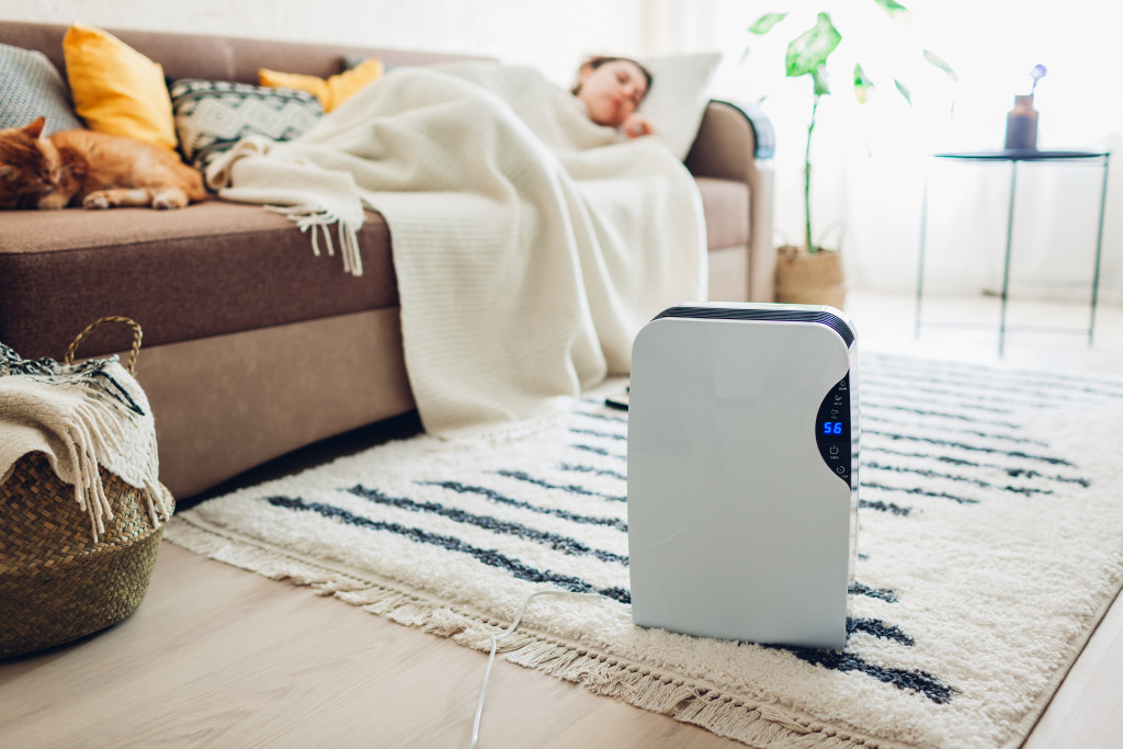 a sleeping woman next to a humidifier